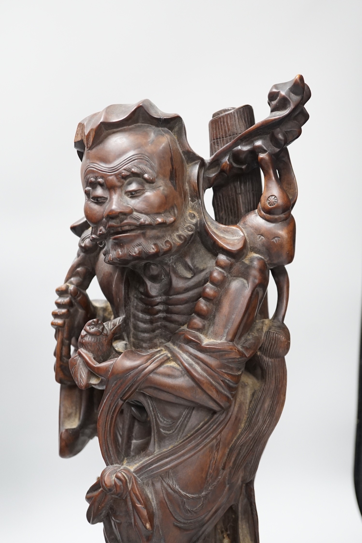 Two Chinese hardwood figures of luohans, early 20th century Tallest 48cm